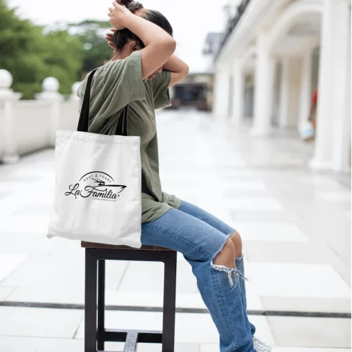 AI Designer-Girl sitting on chair carrying canvas bag logo mockup